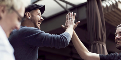 Zwei Männer machen Highfive Due uomini battono il cinque